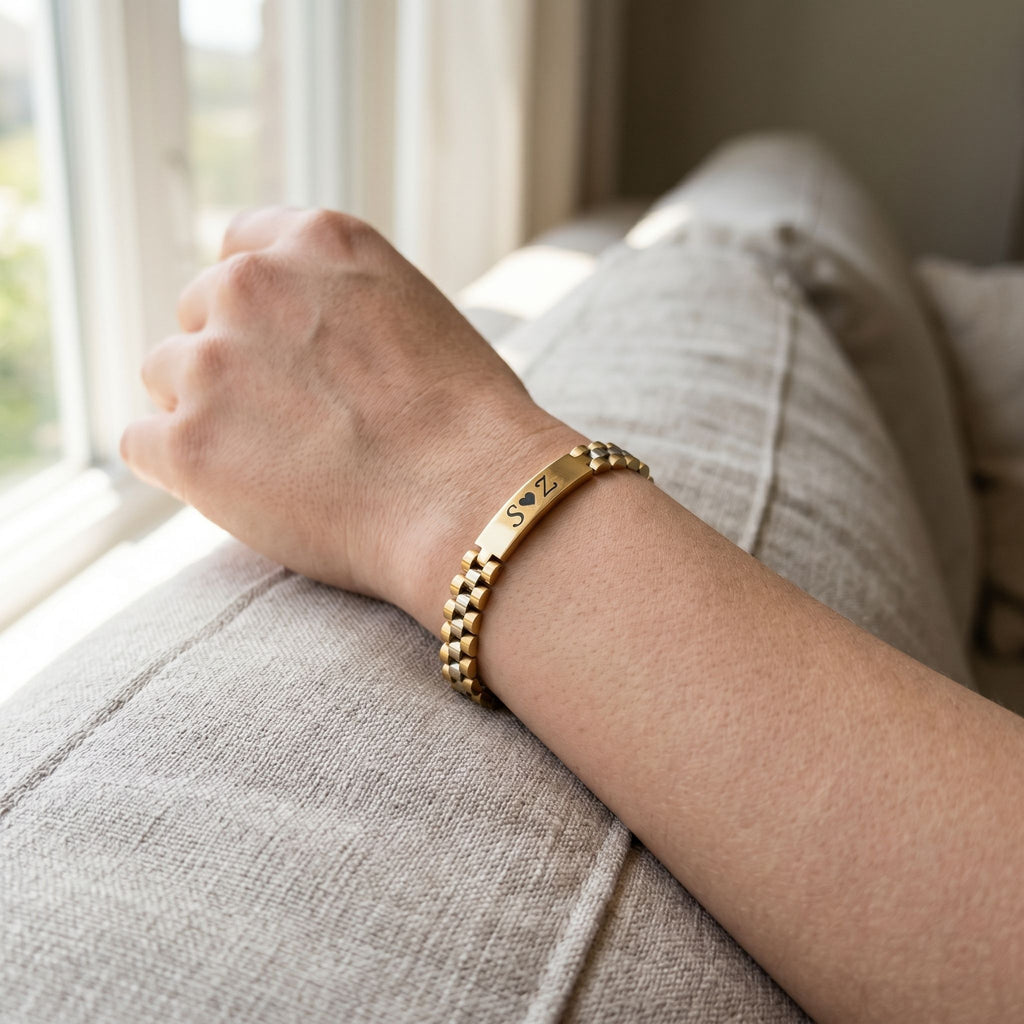 Model's wrist with a tiny engraved Rado-inspired bracelet resting on soft fabric in natural daylight, emphasizing its delicate and personalized design.